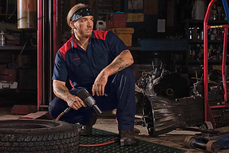 image of auto mechanic working with towels and mats